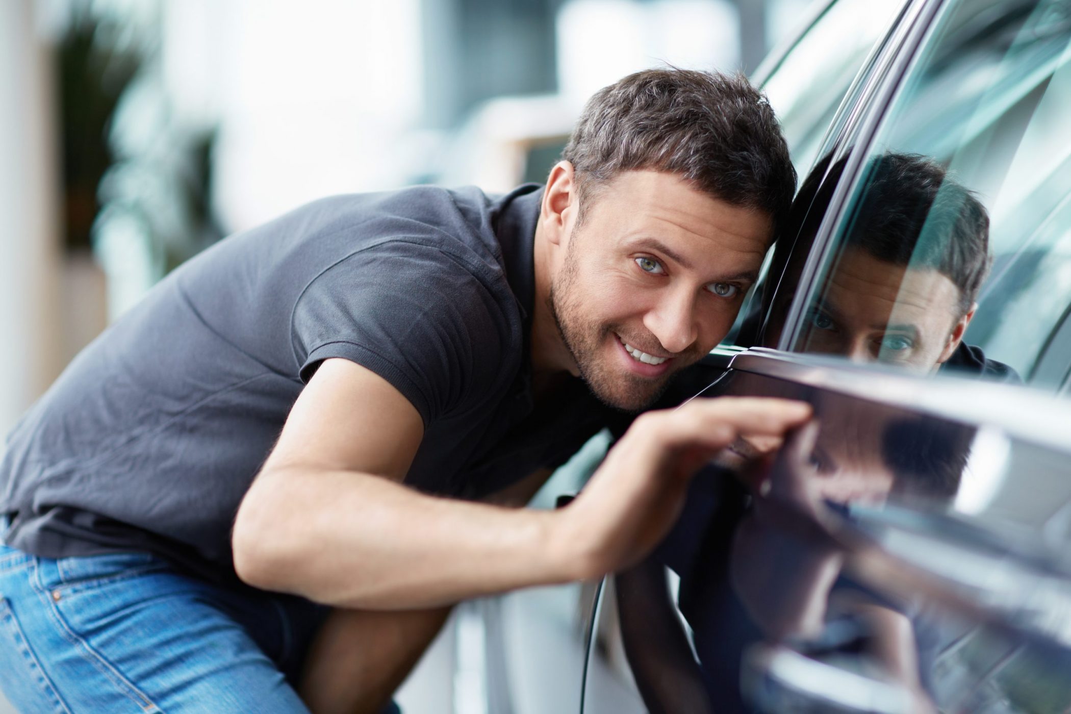 A man enjoying a perfect car condition after PDR performed